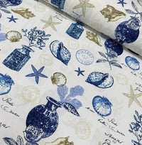 Upholstery fabric with a vintage print featuring sea shells and starfish in shades of blue and white.