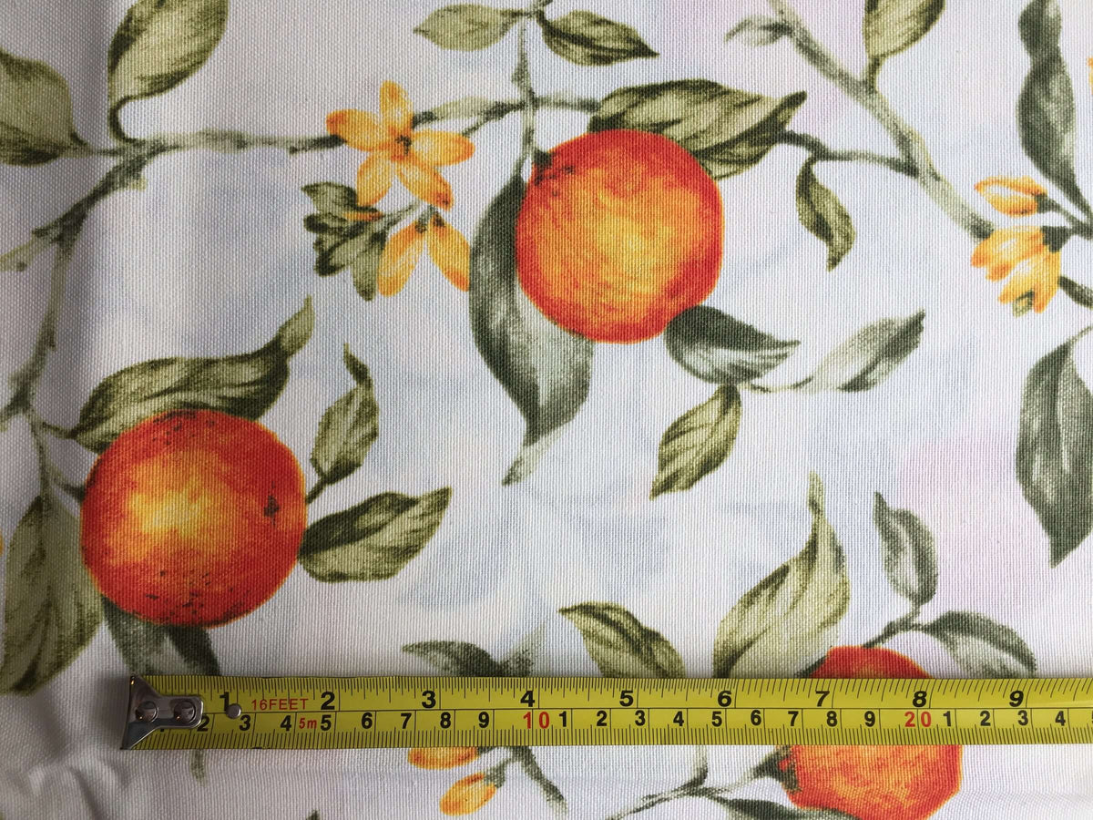 Cotton curtain upholstery fabric printed with orange fruit tree and green leaves on a white background.