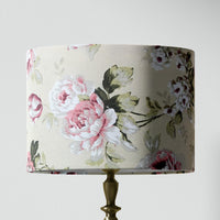 Pink and white floral patterned table lampshade on a white background.