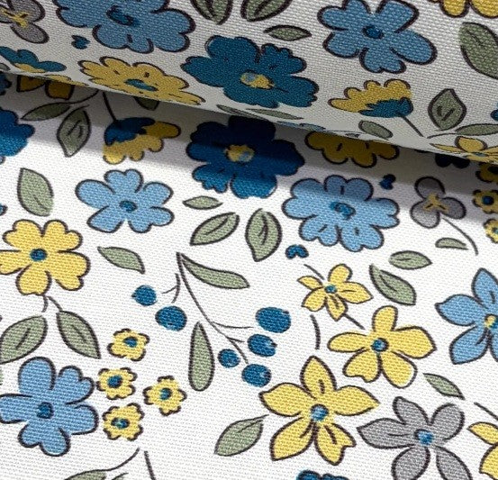 Close up of floral fabric pattern with blue, yellow, and gray flowers on a white background.