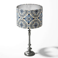 Table lampshade with a blue spanish tile pattern on a white background.