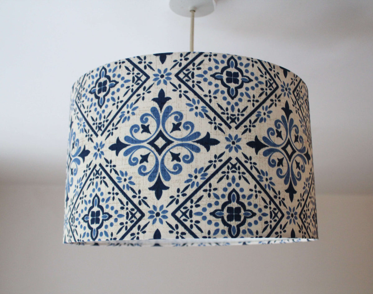 Blu white ceramic tile lampshade with a geometric floral pattern on a plain background.