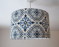 Blu white ceramic tile lampshade with a geometric floral pattern on a plain background.