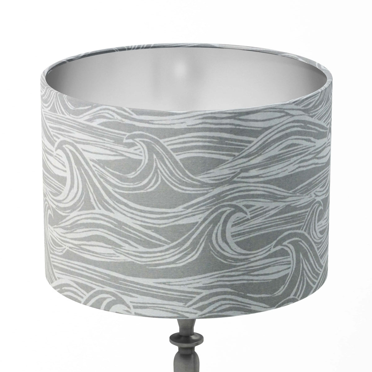 Grey and white table lampshade with wavy pattern on a white background.