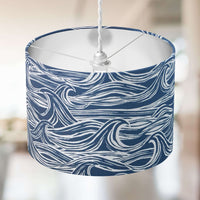 Nautical lampshade with denim blue and white wave pattern on a blurred background.