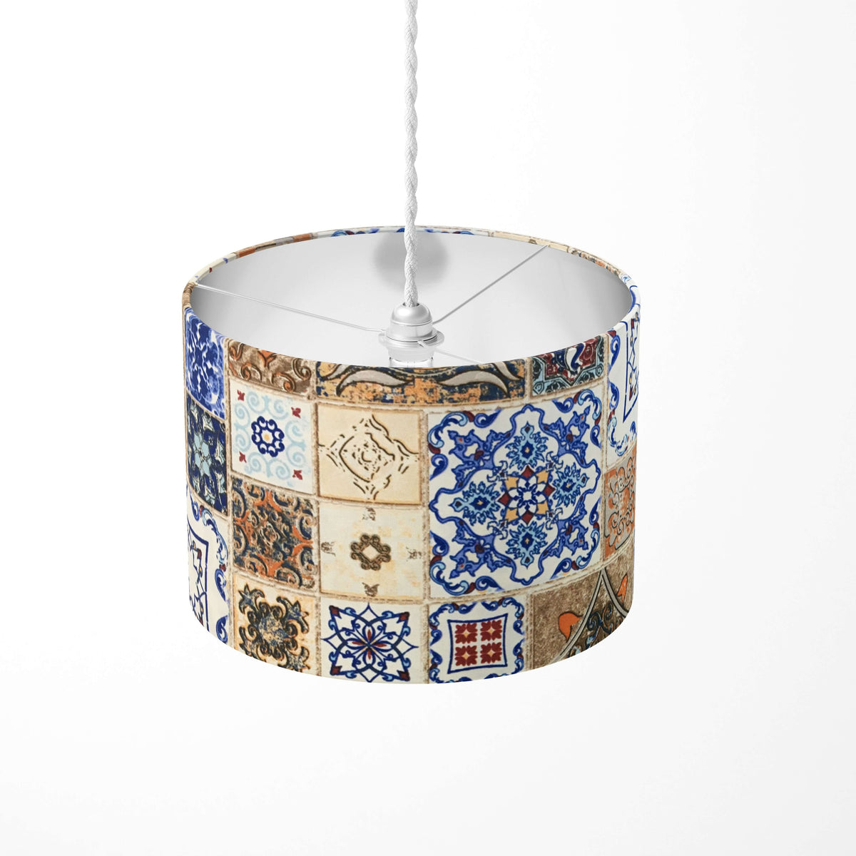 Decorative tile ceiling pendant lampshade with a blue and brown patchwork design on a white background.