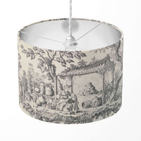 Grey and white toile de jouy patterned drum lampshade.