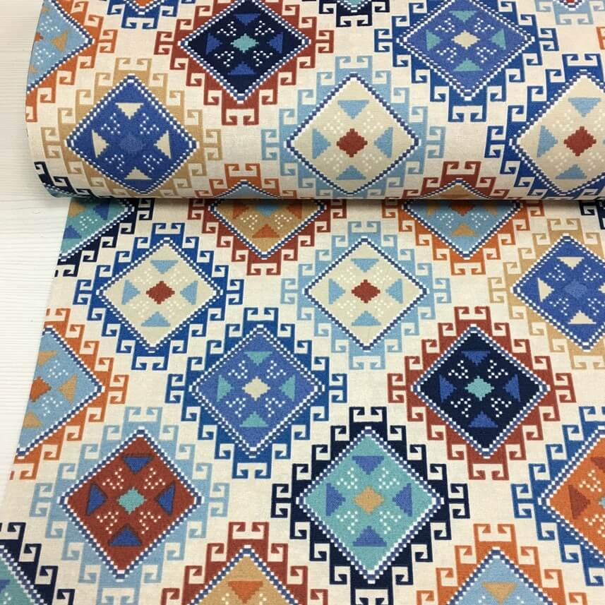Ethnic, native american, geometric upholstery fabric in blue, teal, orange, brick red and white.
