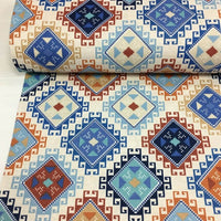 Ethnic, native american, geometric upholstery fabric in blue, teal, orange, brick red and white.