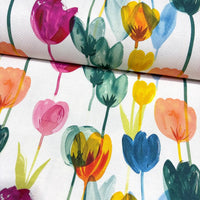 Upholstery & curtain fabric with colourful tulip garden pattern on a white background.