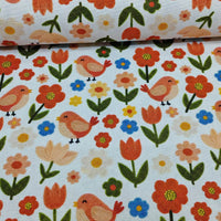 Tulip, flower and scandi bird print upholstery fabric in orange, yellow, blue, green and white.