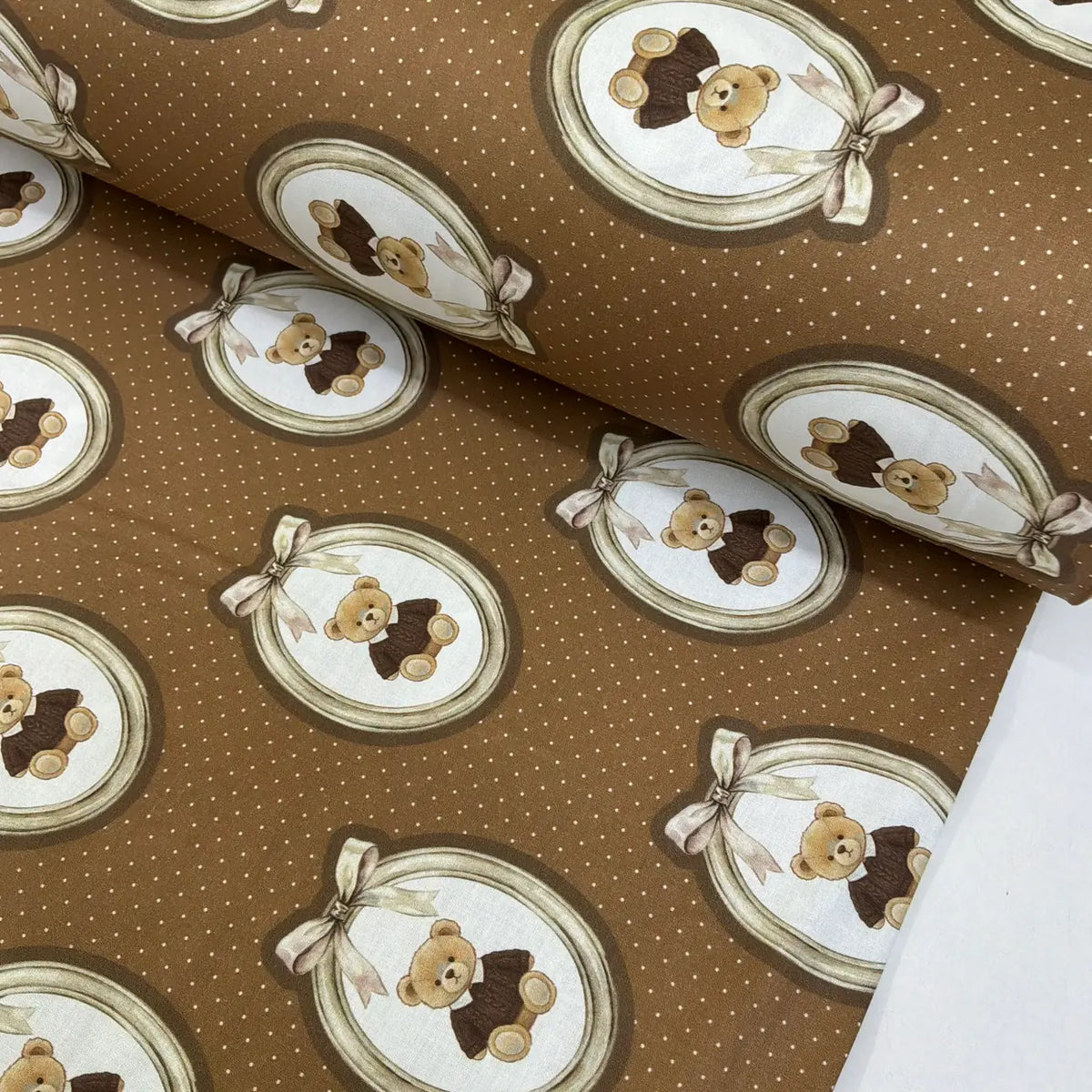 Vintage teddy bear cotton fabric featuring teddy bears in decorative oval frames on a brown polka dot background.
