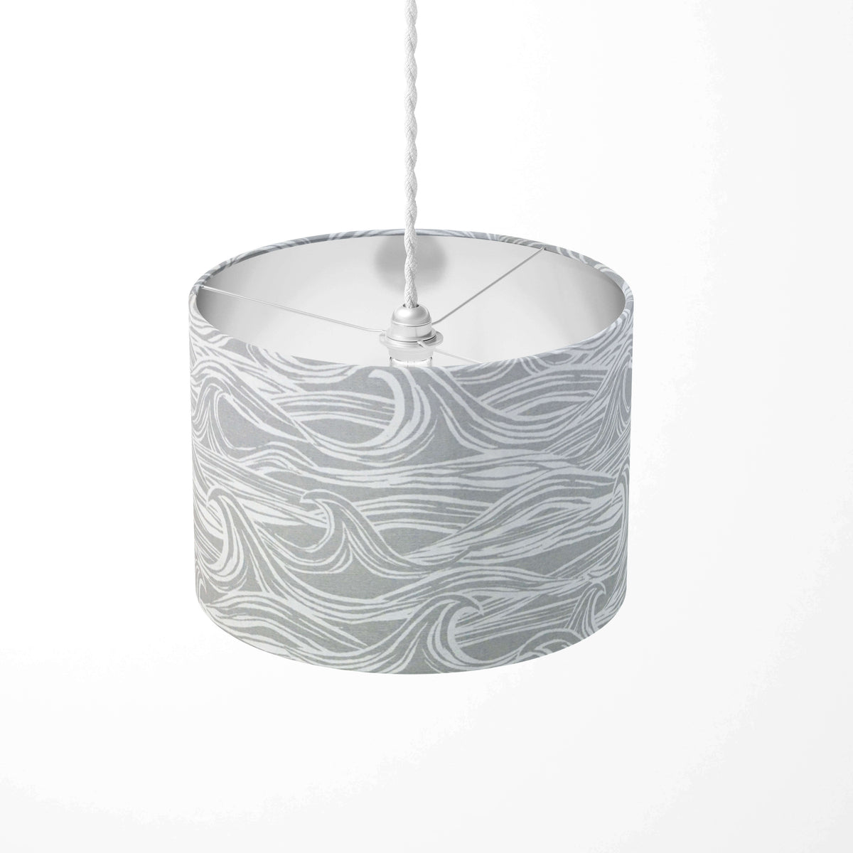 Cylindrical pendant light shade with sea wave pattern on a white background.