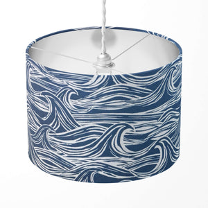 Lampshade with navy blue and white wave pattern on a white background.
