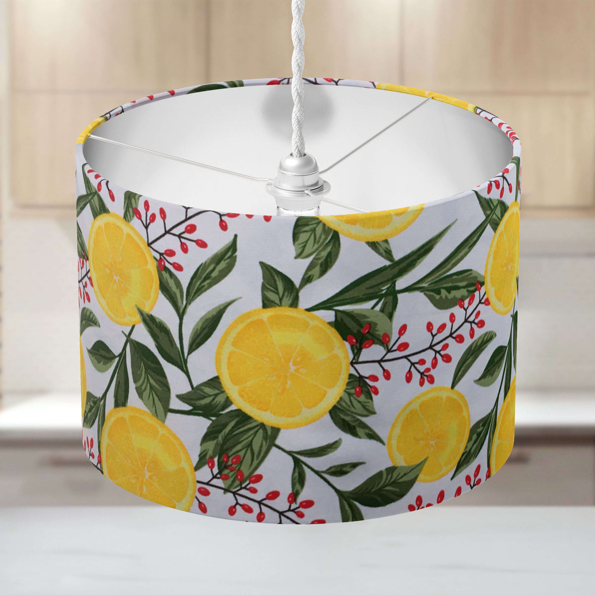 Lampshade with lemon slices and green leaves pattern on a blurred background.