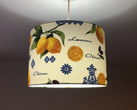 Ceiling light shade with lemon and olive design on a plain background.