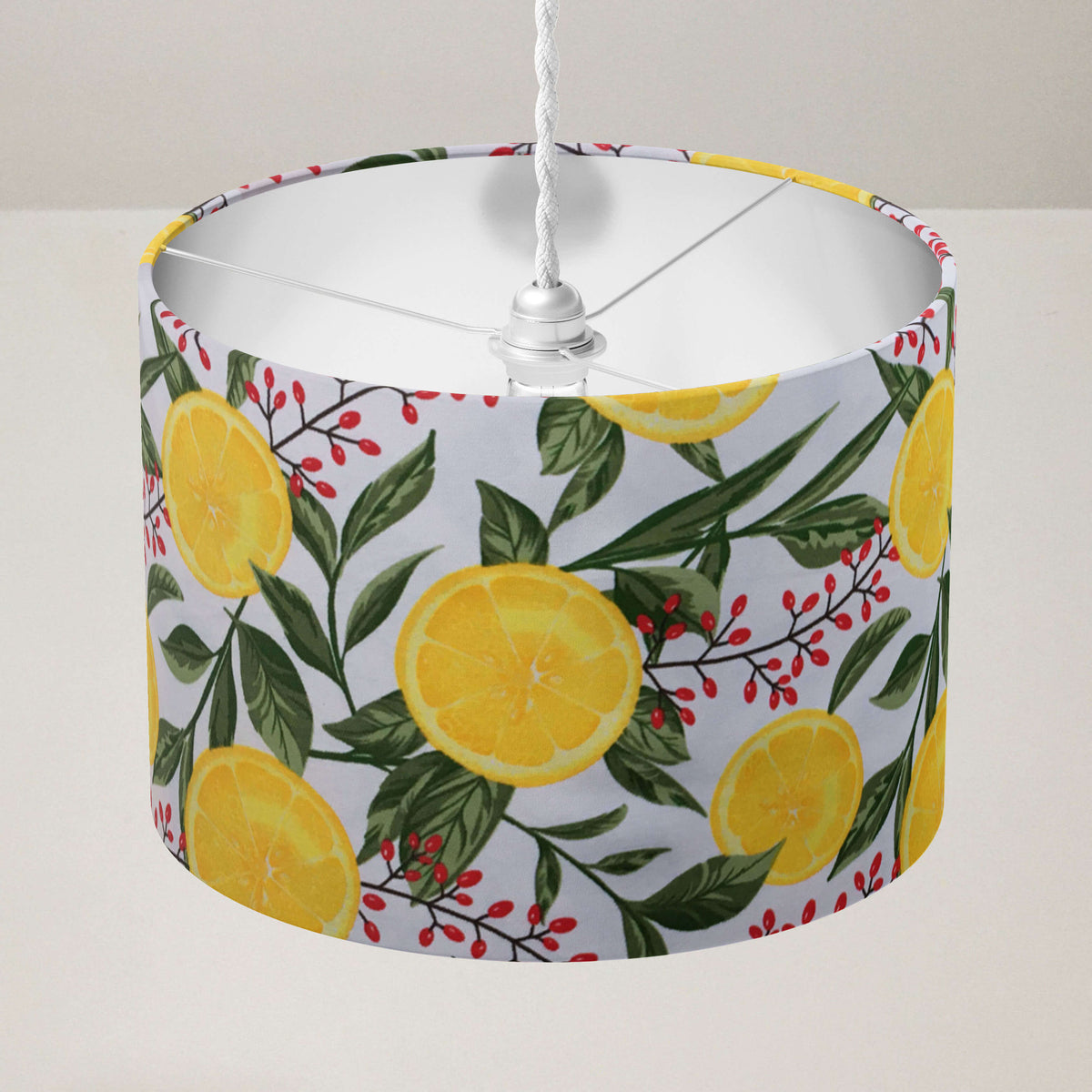 Ceiling light shade with lemon and leaf pattern on a plain background.