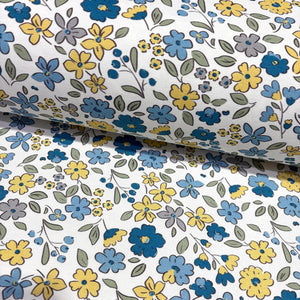 Floral upholstery & curtain fabric patterned with blue, yellow, and gray flowers on a white background.