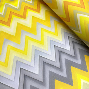 Upholstery curtain fabric with yellow and grey chevron pattern.