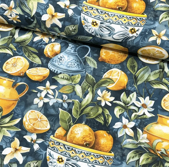 Yellow and teal tapestry upholstery fabric decorated with lemons, leaves, flowers, pots and orchard.
