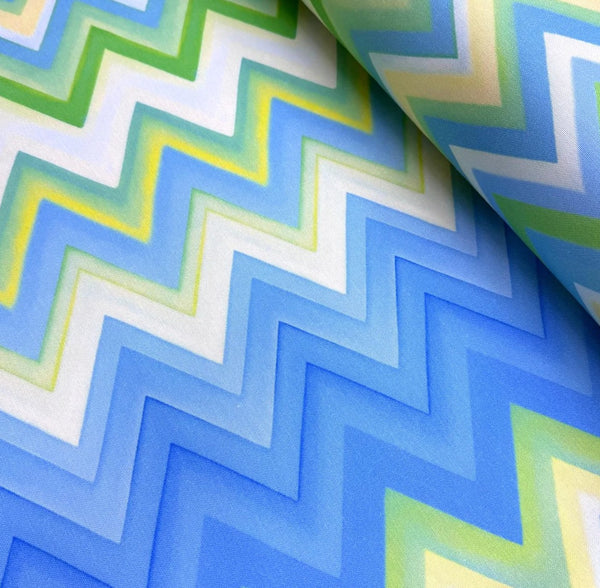 Zig zag patterned upholstery fabric with blue, green, and white colors.