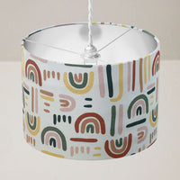 Colourful rainbow ceiling lampshade on a plain background.