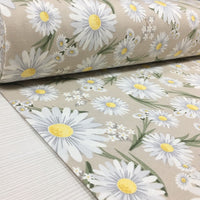 Pastel floral upholstery curtain fabric patterned with white daisies on a beige background.