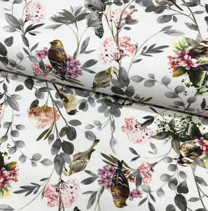 A white fabric featuring a floral and bird print design, suitable for upholstery and curtain making.