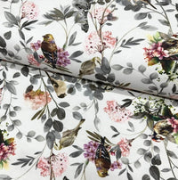 A white fabric featuring a floral and bird print design, suitable for upholstery and curtain making.