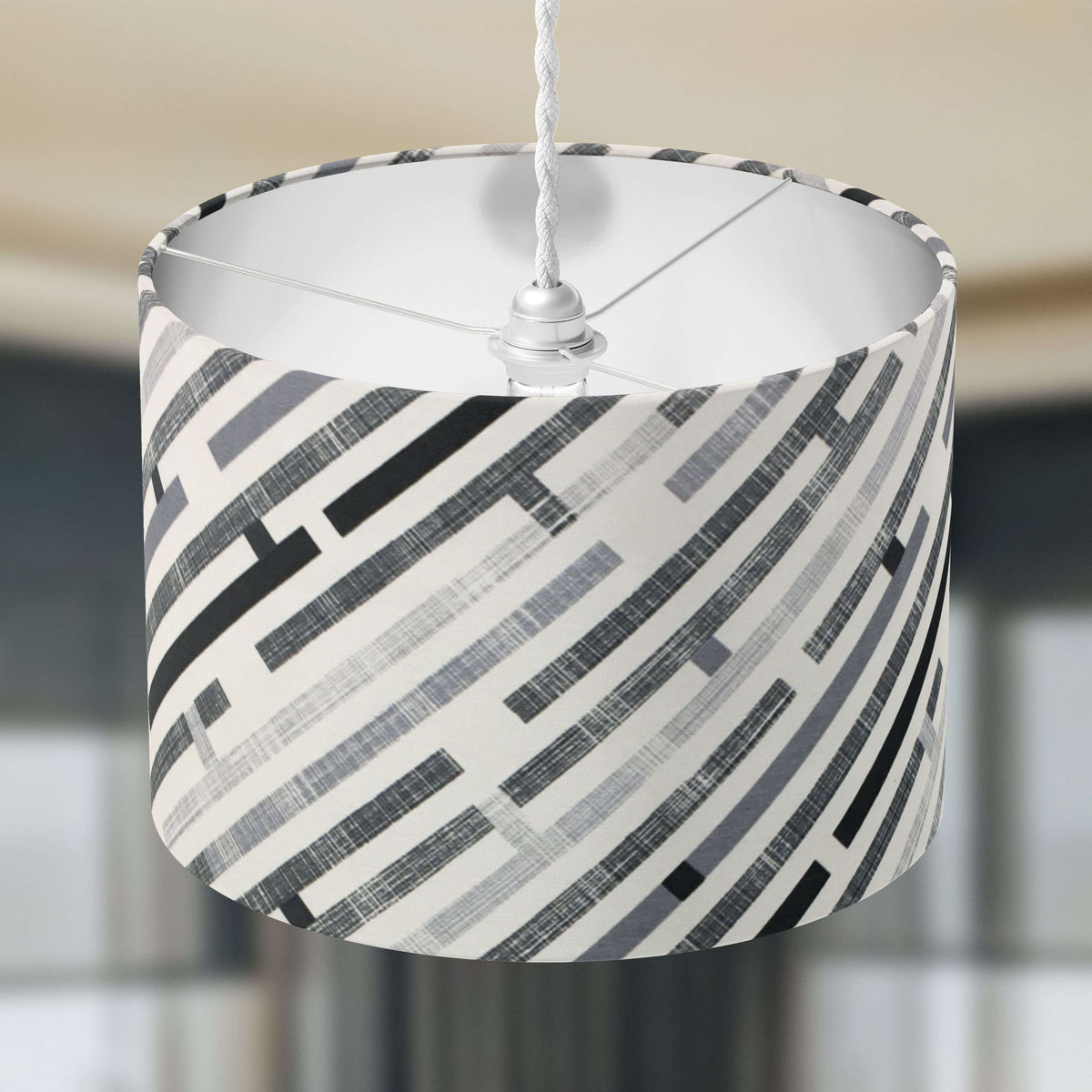 Maze patterned lampshade with geometric design on a neutral background.