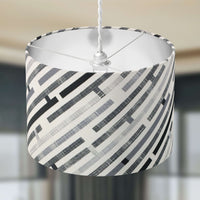 Maze patterned lampshade with geometric design on a neutral background.