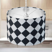 Black and white check ceiling lampshade on a neutral background in a kitchen.