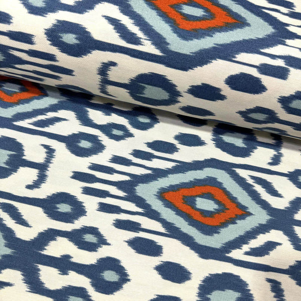 Ikat mallorcan ethnic upholstery fabric with geometric design in azure blue, orange, and white.