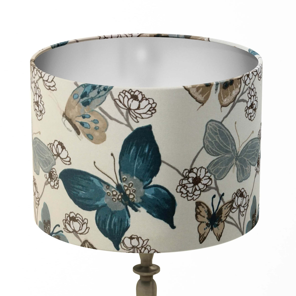 Lampshade with indigo blue exotic butterfly and flower pattern on a white background.