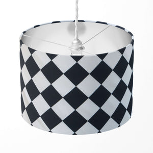 Checkered lampshade with black and white pattern on a white background.