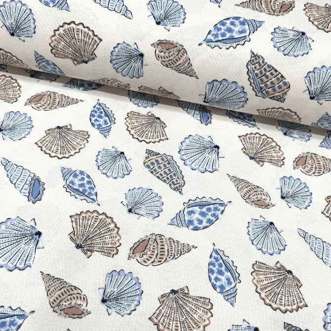 Upholstery curtain fabric with blue and brown sea shell pattern on a white background.