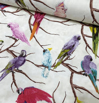 Colourful upholstery fabric patterned with exotic birds in pink, burgundy, purple, green and sky blue.  