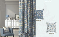 Decorative blue and white curtains and pillows with sea shell pattern in a room setting.