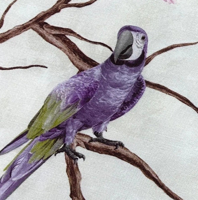 Upholstery fabric patterned with exotic lilac green parrot on a brown branch tree on a white background.
