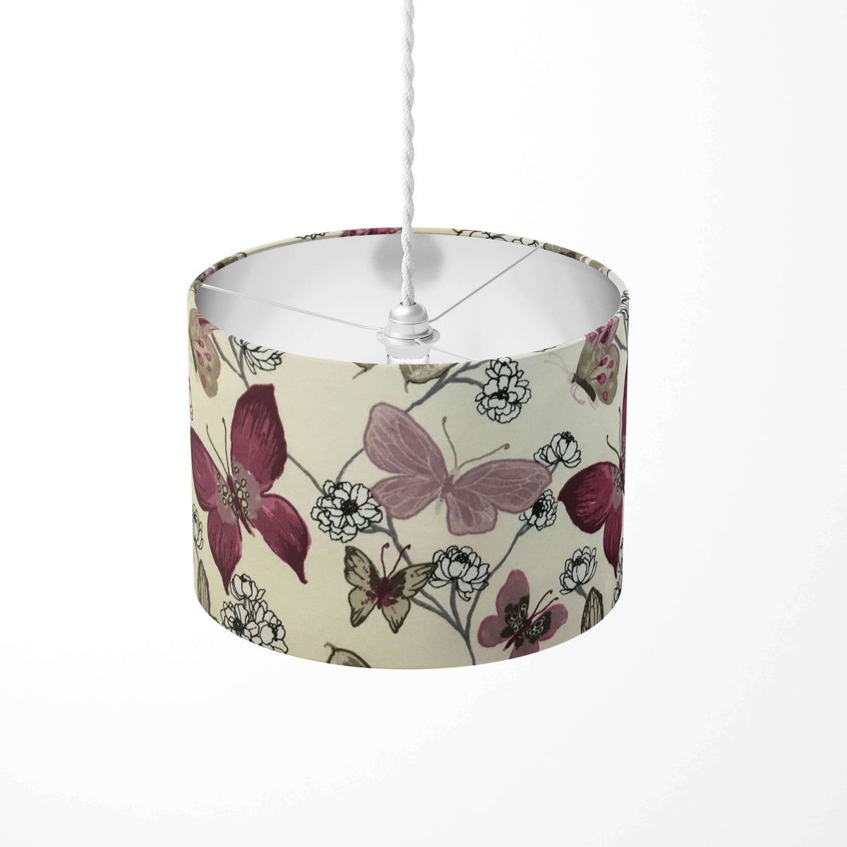 Plum, lilac and beige butterfly and  floral patterned ceiling lampshade on a white background.