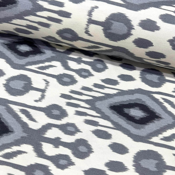 Grey white ikat print upholstery curtain fabric in a boho traditional style.
