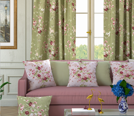 A living room decorated with green curtains and cushions printed with pink and burgundy roses.