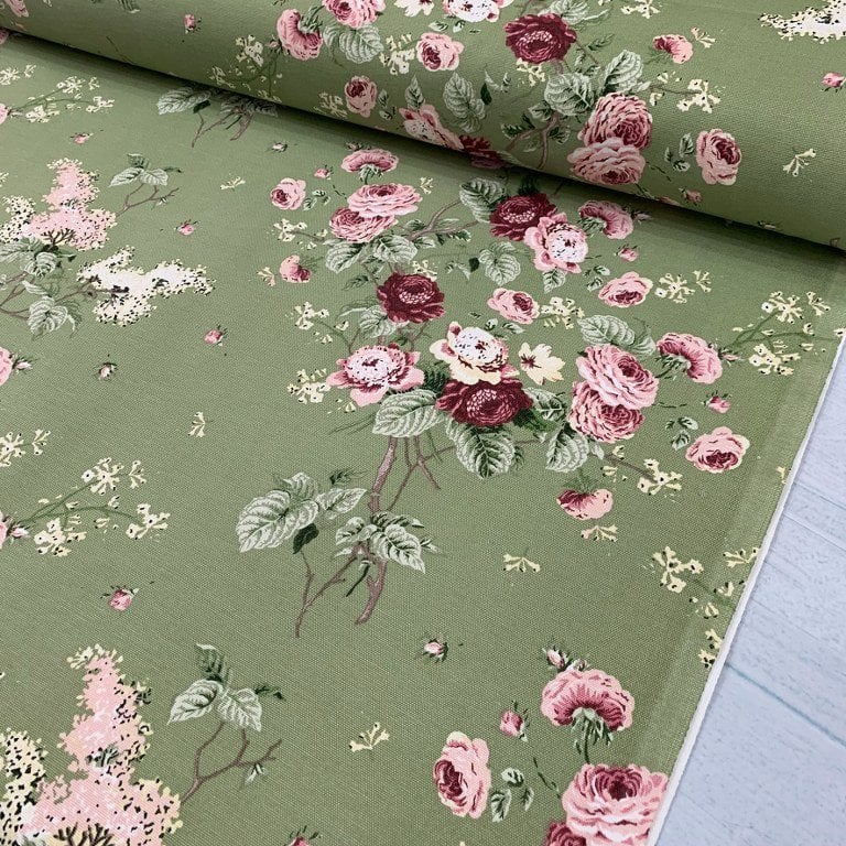 Pink and burgundy roses on moss green upholstery curtain fabric.