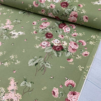 Pink and burgundy roses on moss green upholstery curtain fabric.