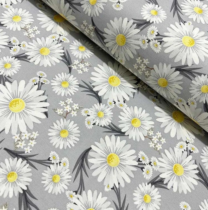 A grey floral fabric with a pattern of yellow white daisies, for upholstery, curtain making and home decor crafts.