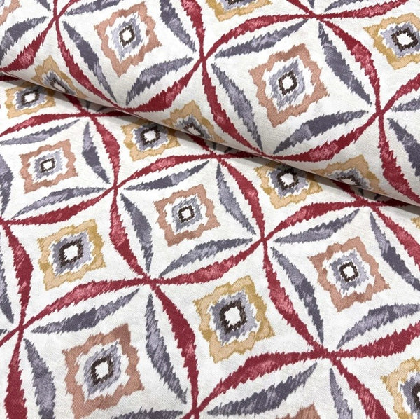 Burgundy mustard and grey geometric ikat patterns on white cotton canvas upholstery fabric.