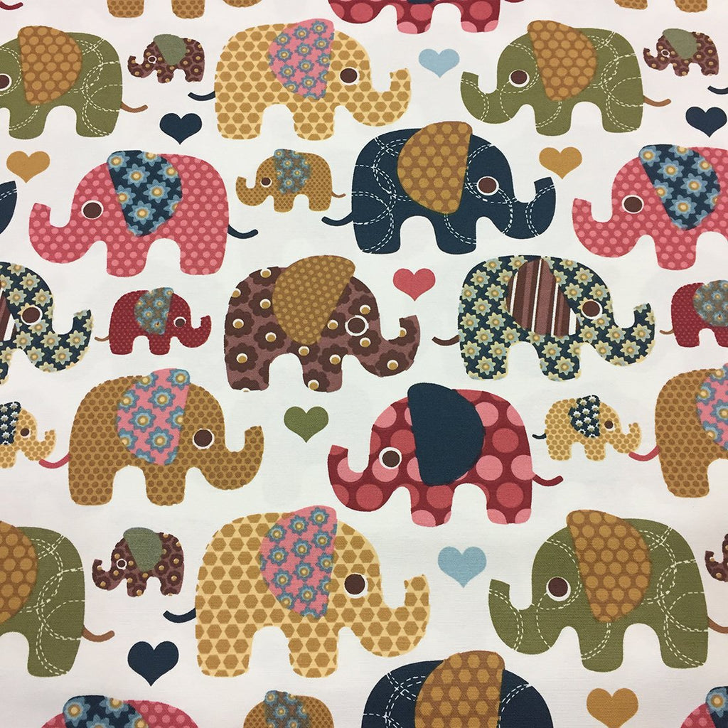 Printed cotton canvas fabric patterned with floral circle patchwork elephants in green yellow pink brown navy and colourful hearts