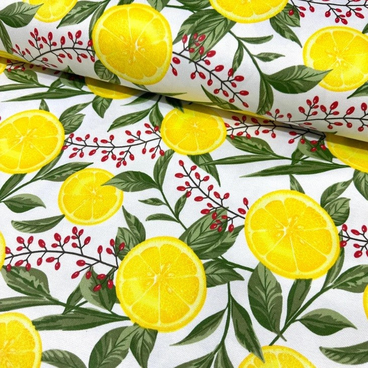 Yellow summer lemons and green leaves printed on white cotton canvas fabric
