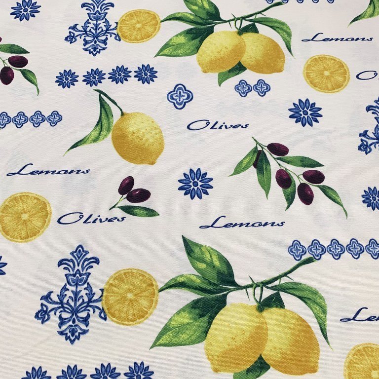 Yellow lemons and black olives with green leaves and blue decorations are printed on white cotton canvas upholstery fabric