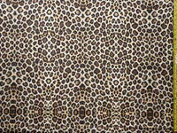 Cheetah print upholstery fabric with a measuring tape for scale.